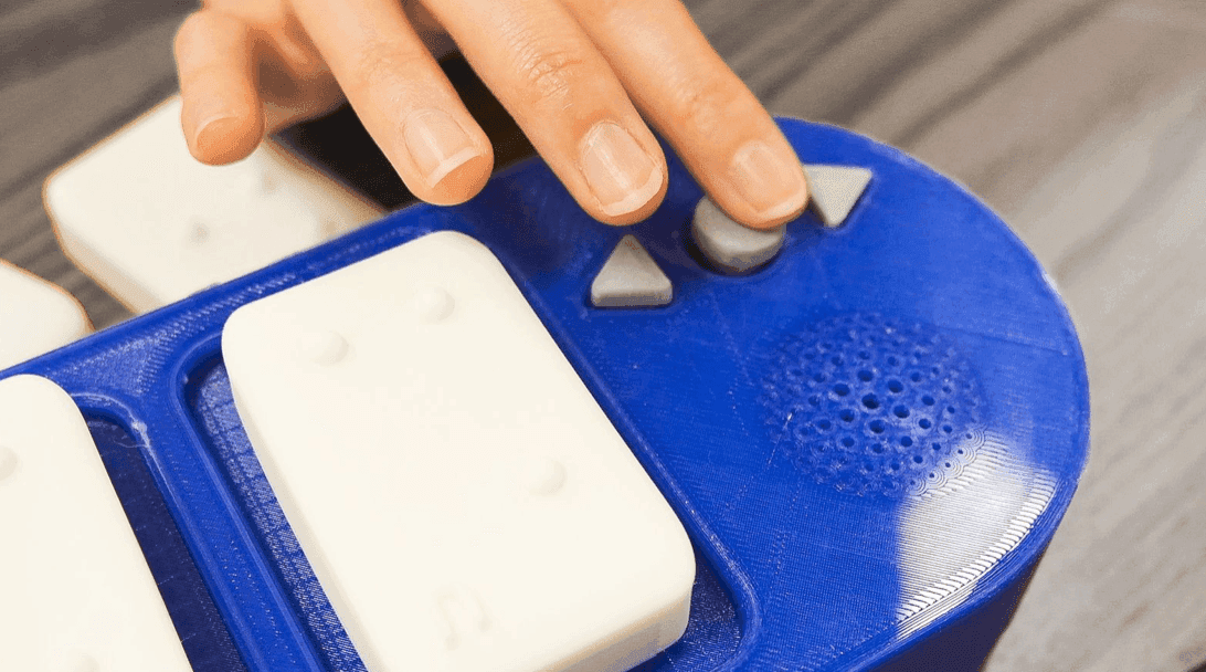 Close-up of a fingertip on the three-button cluster, triangular arrows and a round select button
