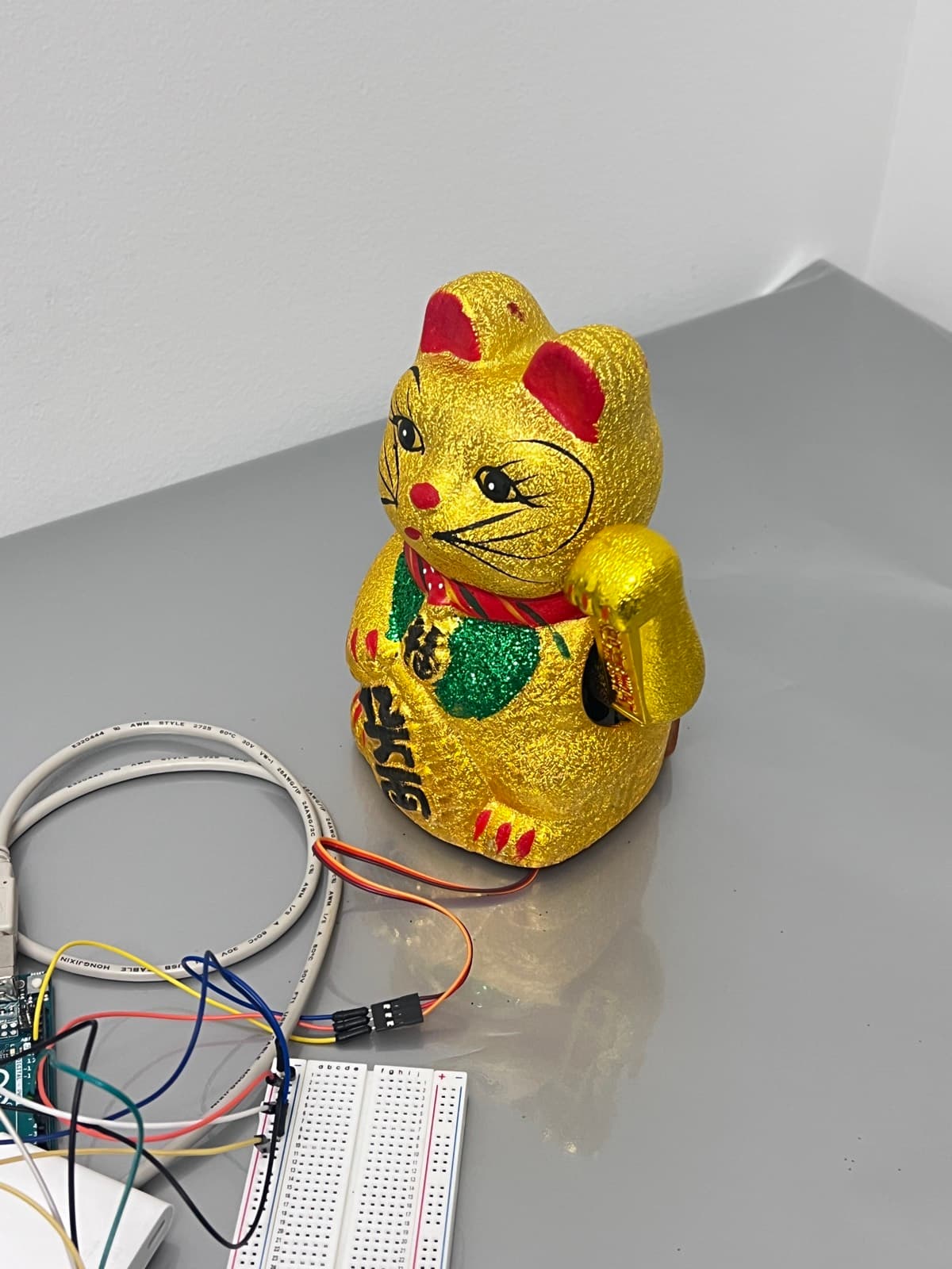 Mechanism back inside the shell — a lucky cat that keeps time.
